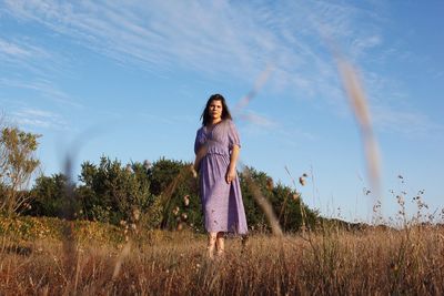 Portrait of woman standing on land against sky