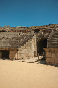 Arched exit in the bleachers of roman amphitheater at the huge archaeological site of merida, spain.