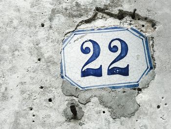 Close-up of number 22 on weathered wall