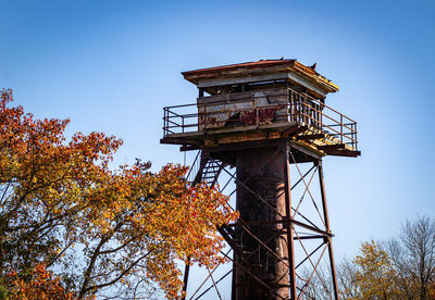 Watch tower with fall leaves around it.