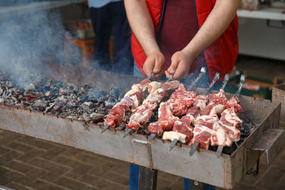 Midsection of man preparing food