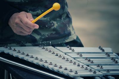 Cropped hand of man holding equipment