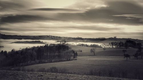 Scenic view of landscape against cloudy sky