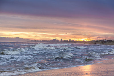 Scenic view of sea against dramatic sky during sunset