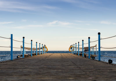 Pier over sea against sky