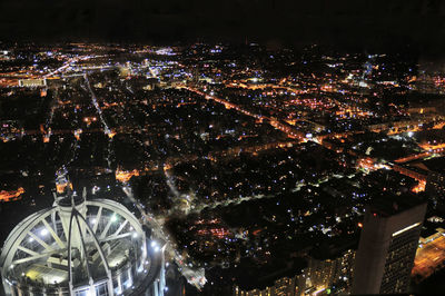 High angle view of illuminated buildings in city at night