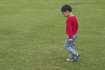 Boy walking on field