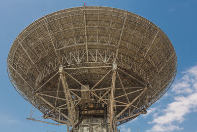 Low angle view of communications tower against sky