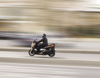 Man riding motorcycle on road, bike rider panning shot, fast bike, bike moving background blur