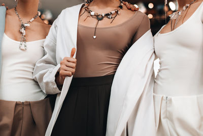 Midsection of woman standing against white background