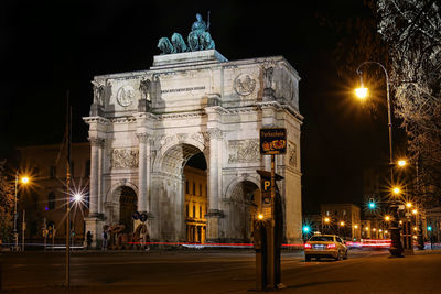 View of munich city gate lit up at night