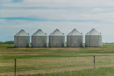 Barn on field against sky