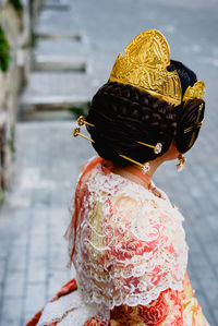 Rear view of woman standing against blurred background