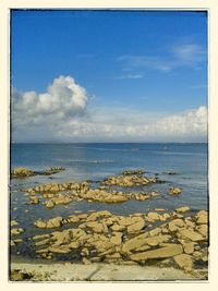 Scenic view of sea against cloudy sky