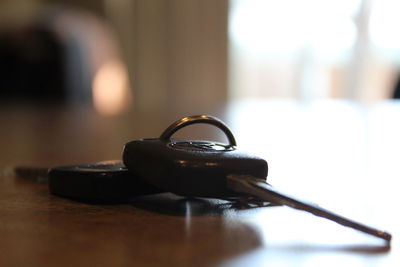 Close-up of car key on table
