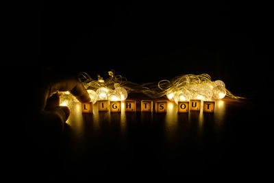 Close-up of illuminated lighting equipment in the dark
