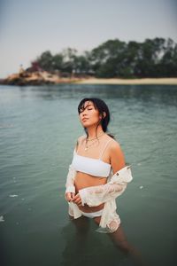 Young woman standing in lake
