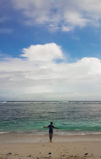 Man on beach against sky