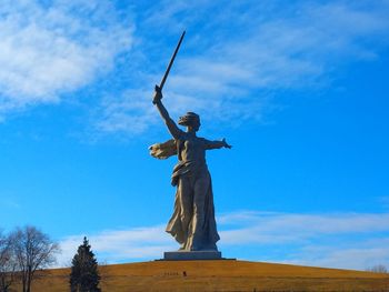 Low angle view of statue against blue sky