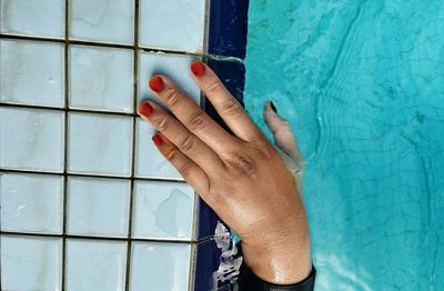 Cropped image of hand in swimming pool