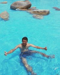 High angle portrait of man swimming in sea