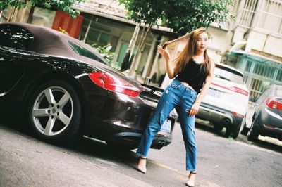 Full length of woman standing in car