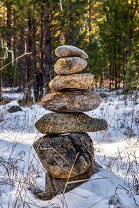 Stack of stones on snow covered land