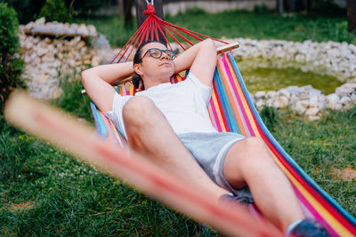 Man relaxingin hammock in the yard