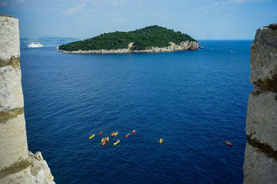 High angle view of rocks in sea against sky