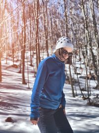 Full length of woman standing on snow covered land