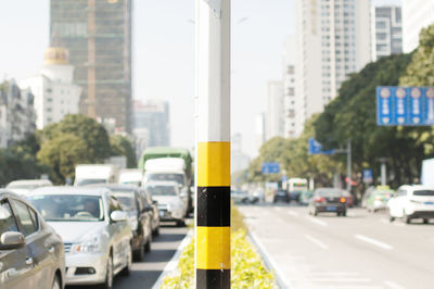 Close-up of yellow traffic on road in city