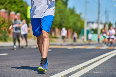 Rear view of man running on road