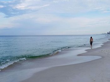 Man on beach against sky