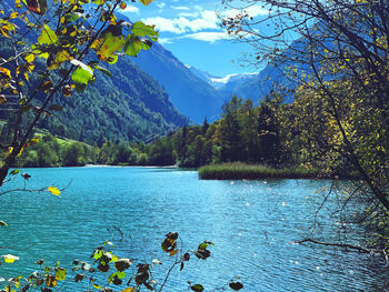 Scenic view of lake and mountains against sky