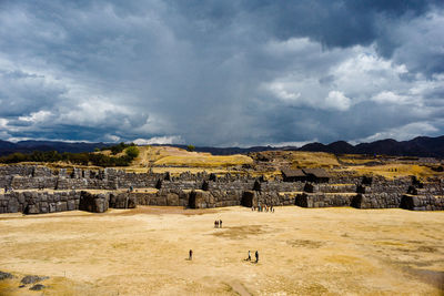 Panoramic view of old ruins against cloudy sky