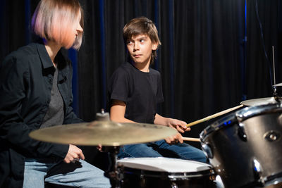 Teacher teaching student drumming