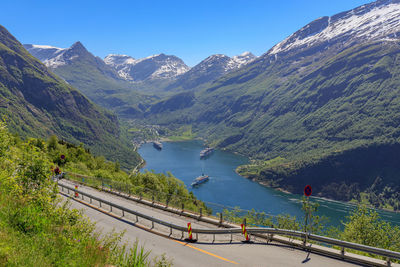 Scenic view of lake by mountains against sky