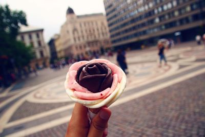 Close-up of hand holding ice cream cone