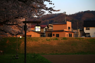 Houses by street in town against sky