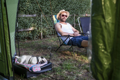 Man sitting on chair in yard