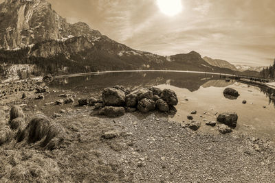 Scenic view of rocks by lake against sky