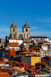 Buildings in town against blue sky