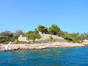 Scenic view of calm sea against clear blue sky