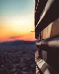 Close-up of airplane wing over sea during sunset