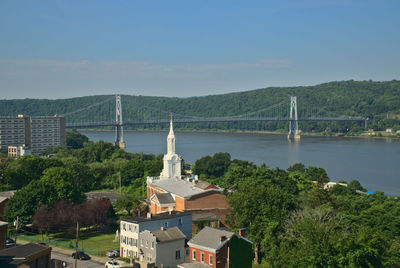 View of bridge over sea against buildings