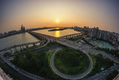 Multiple lane highway against clear sky during sunset