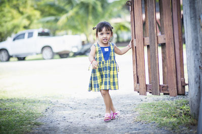 Full length of girl standing on road