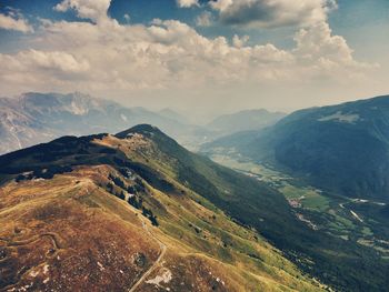 Scenic view of mountains against cloudy sky