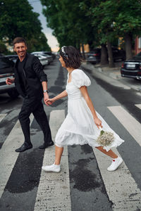 Rear view of couple walking on street