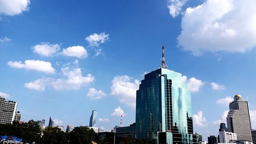 Low angle view of buildings against cloudy sky